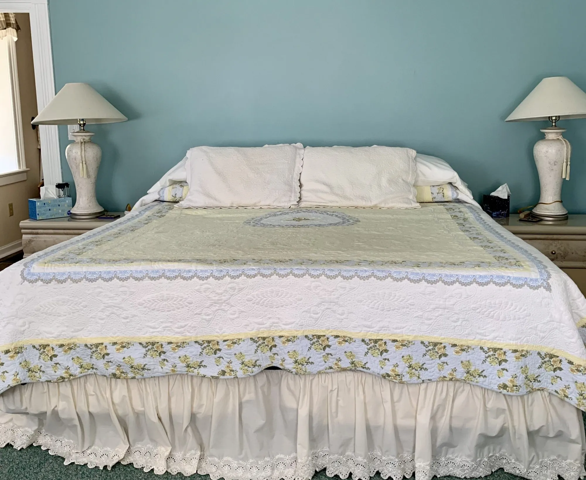 The Master Suite with a king bed against a soft blue wall